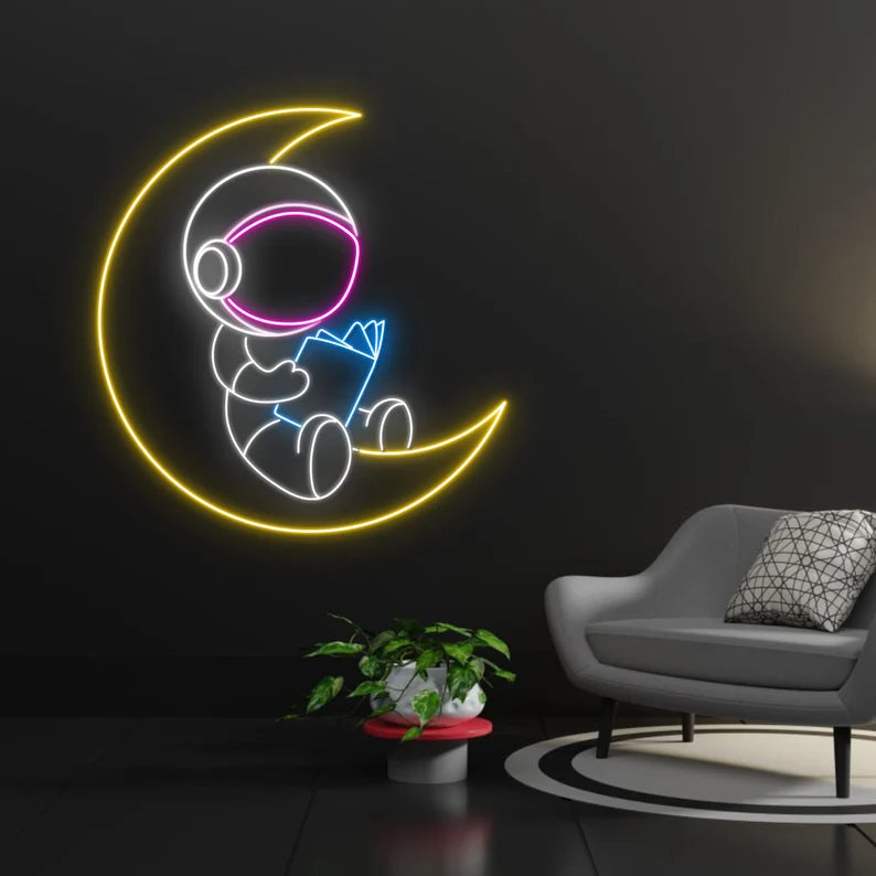 AUSTRONAUTA LUNA LEYENDO